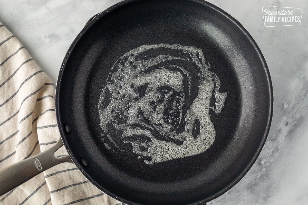 Skillet with melted butter.