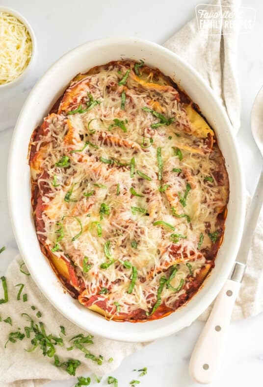 A baking dish full of chicken parmesan stuffed shells