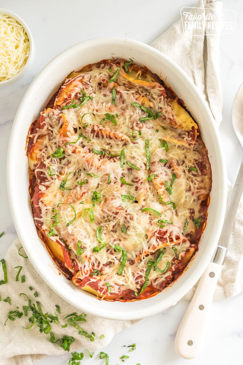 A baking dish full of chicken parmesan stuffed shells