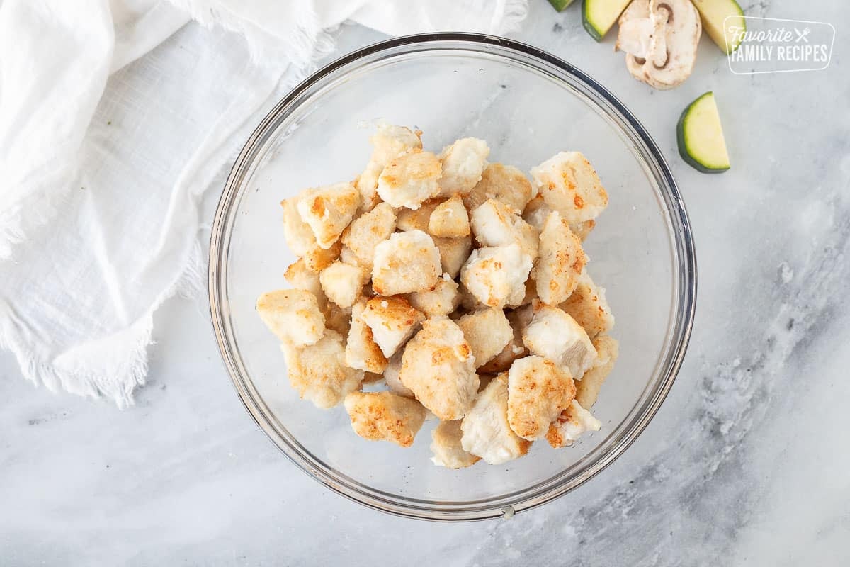 Bowl of cooked chicken pieces.