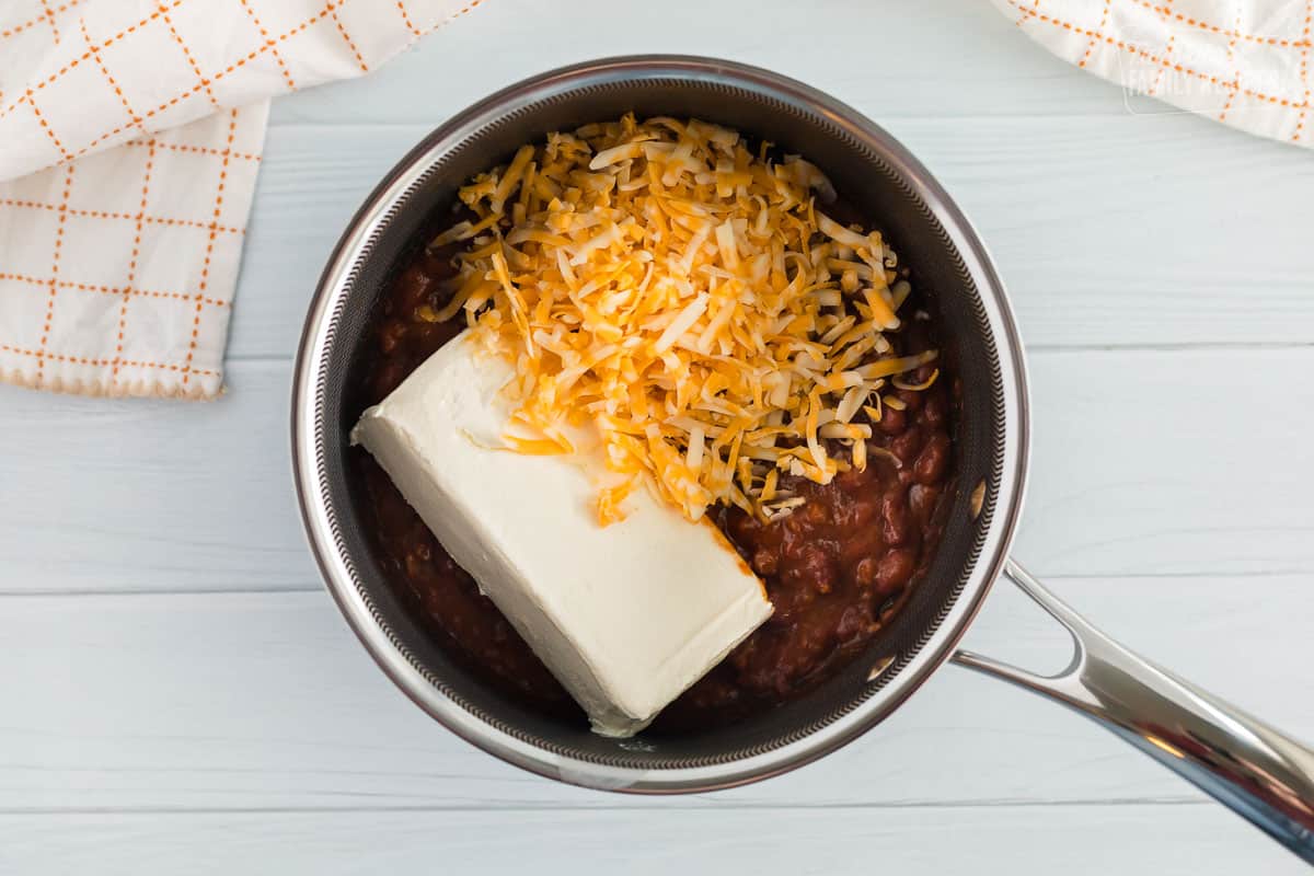 Chili, Cream cheese and shredded colby jack cheese inside a sauce pan