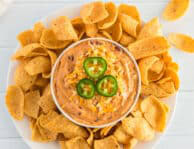 a Plate of chili cheese dip and chips