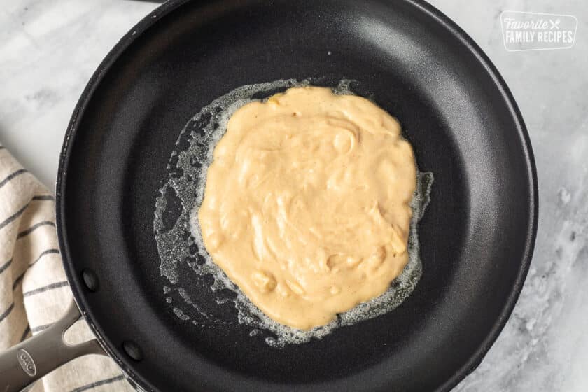 Skillet with a cooking Peanut Butter Pancake.