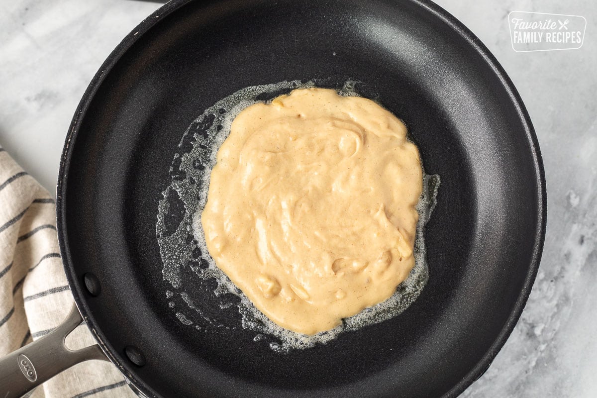 Skillet with a cooking Peanut Butter Pancake.