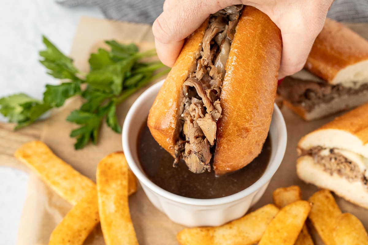 Dipping a French Dip Sandwich in au jus.