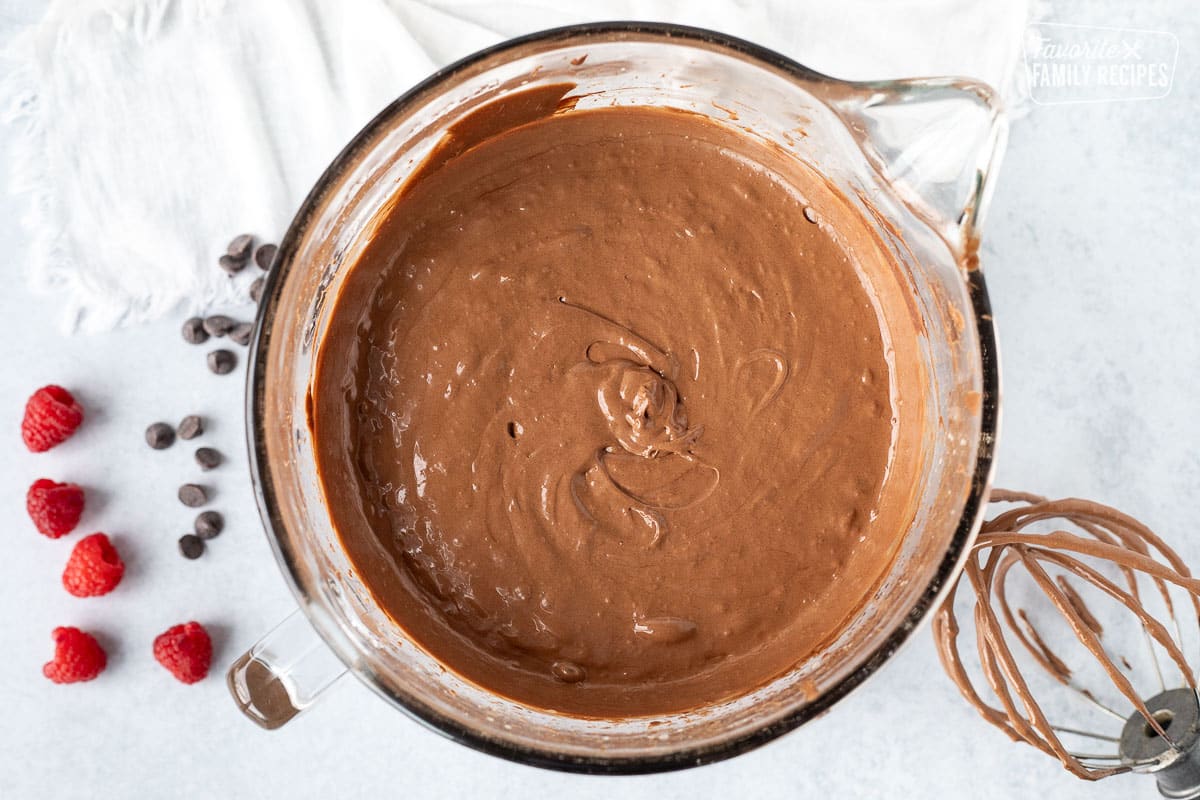 Gluten Free Chocolate Cake batter in a mixing bowl. Whisk attachment on the side.
