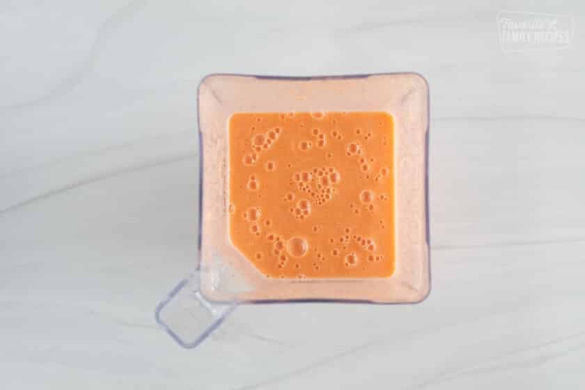 Golden detox smoothie inside a blender