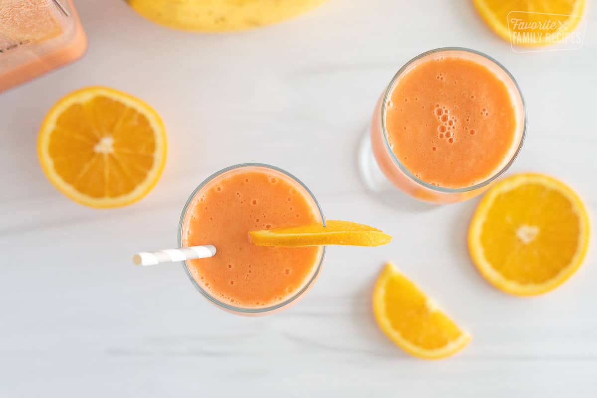 Two glasses of golden detox smoothie with orange slices