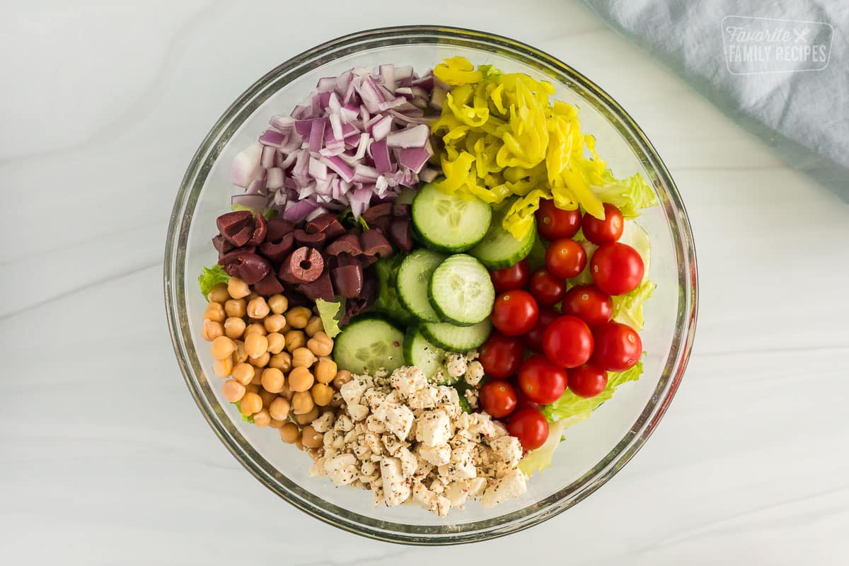 Ingredients for greek salad all inside a big bowl