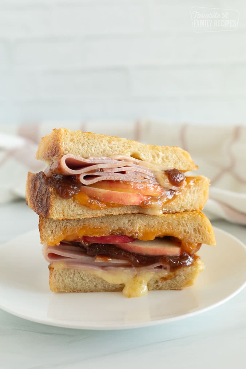 Halves of a grilled ham and cheese stacked on top of each other