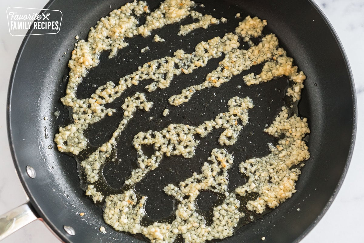 Garlic and ginger sautéing in a pan