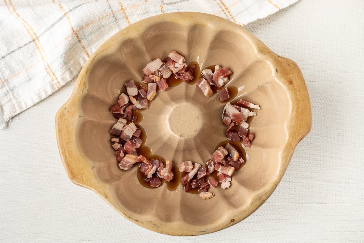 Bundt pan with maple syrup and cut bacon.