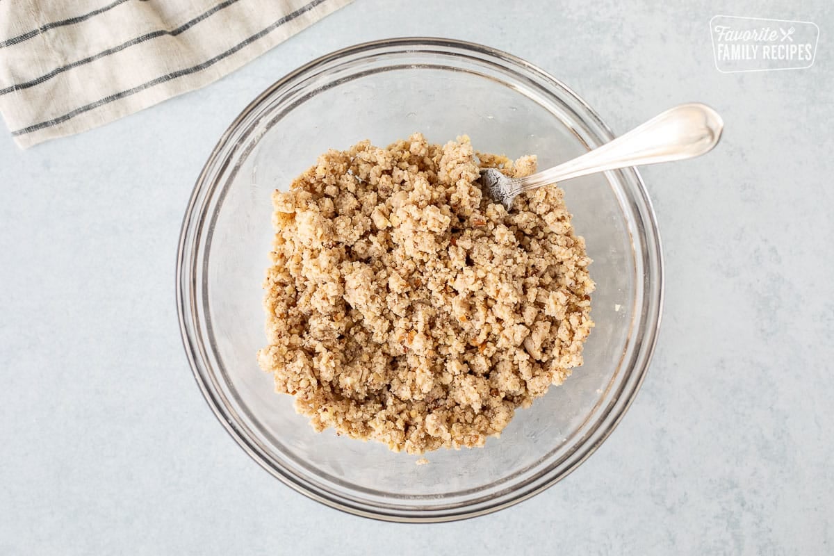 Mixing bowl with crumbly combined Mud Pie crust with a fork.