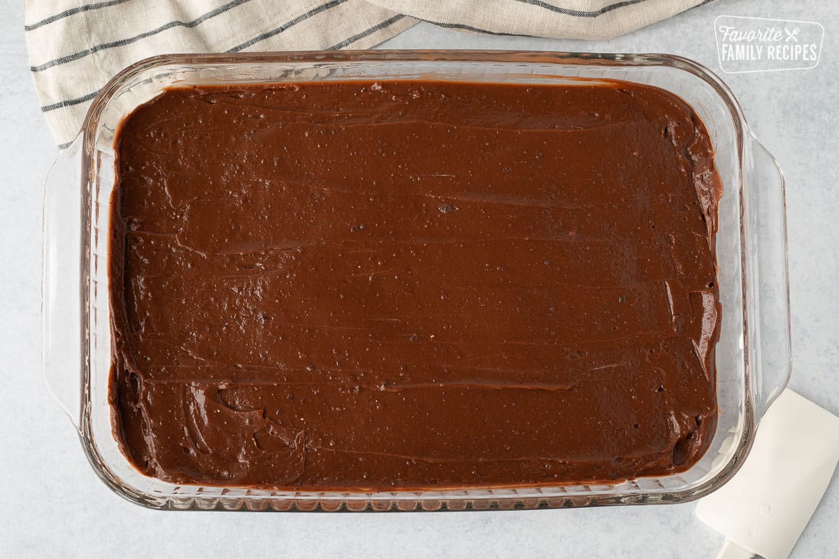Glass baking dish with a smoothed out layer of chocolate butterscotch pudding layer.