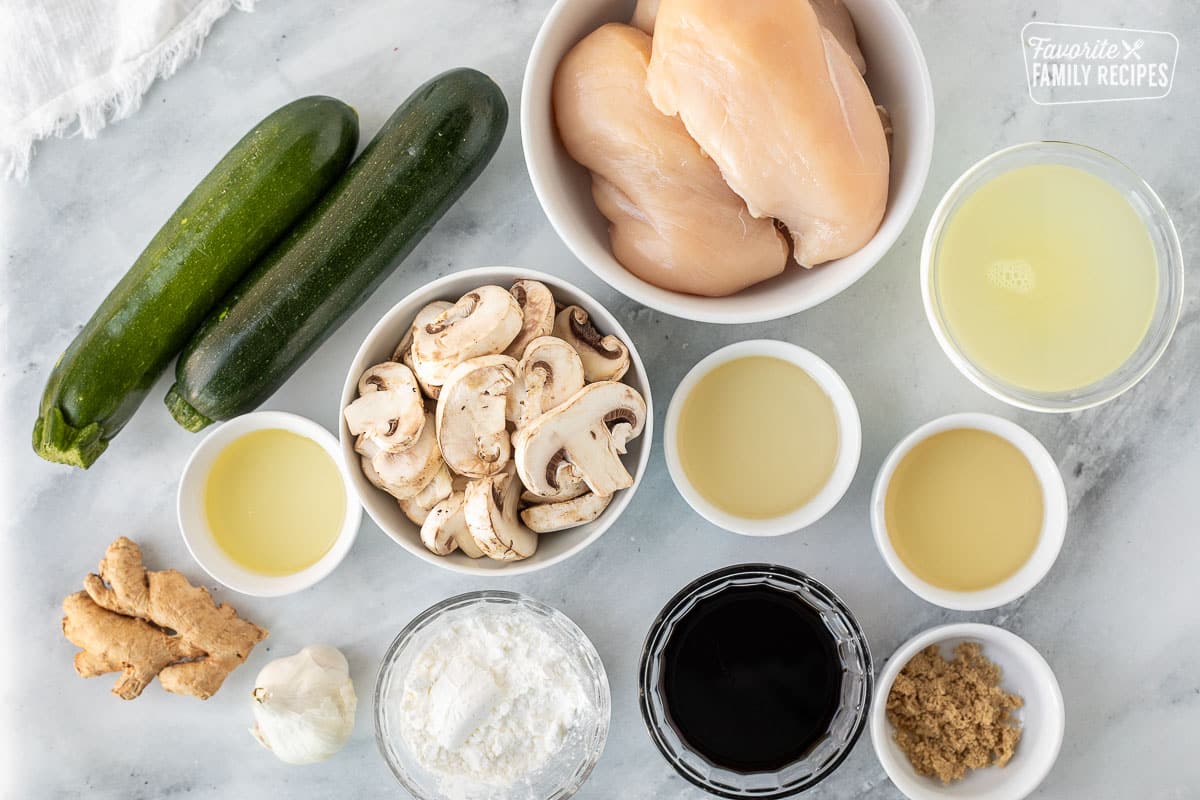 Ingredients to make Panda Express Mushroom Chicken including chicken, mushrooms, oil, white wine, rice vinegar, soy sauce, brown sugar, chicken broth, corn starch, zucchini, ginger and garlic.