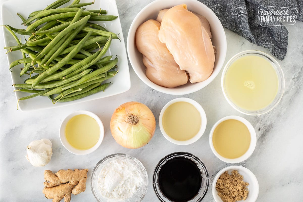 Ingredients to make Panda Express String Bean Chicken including green beans, chicken, chicken broth, onion, rice vinegar, white wine, oil, garlic, soy sauce, ginger, corn starch and brown sugar.