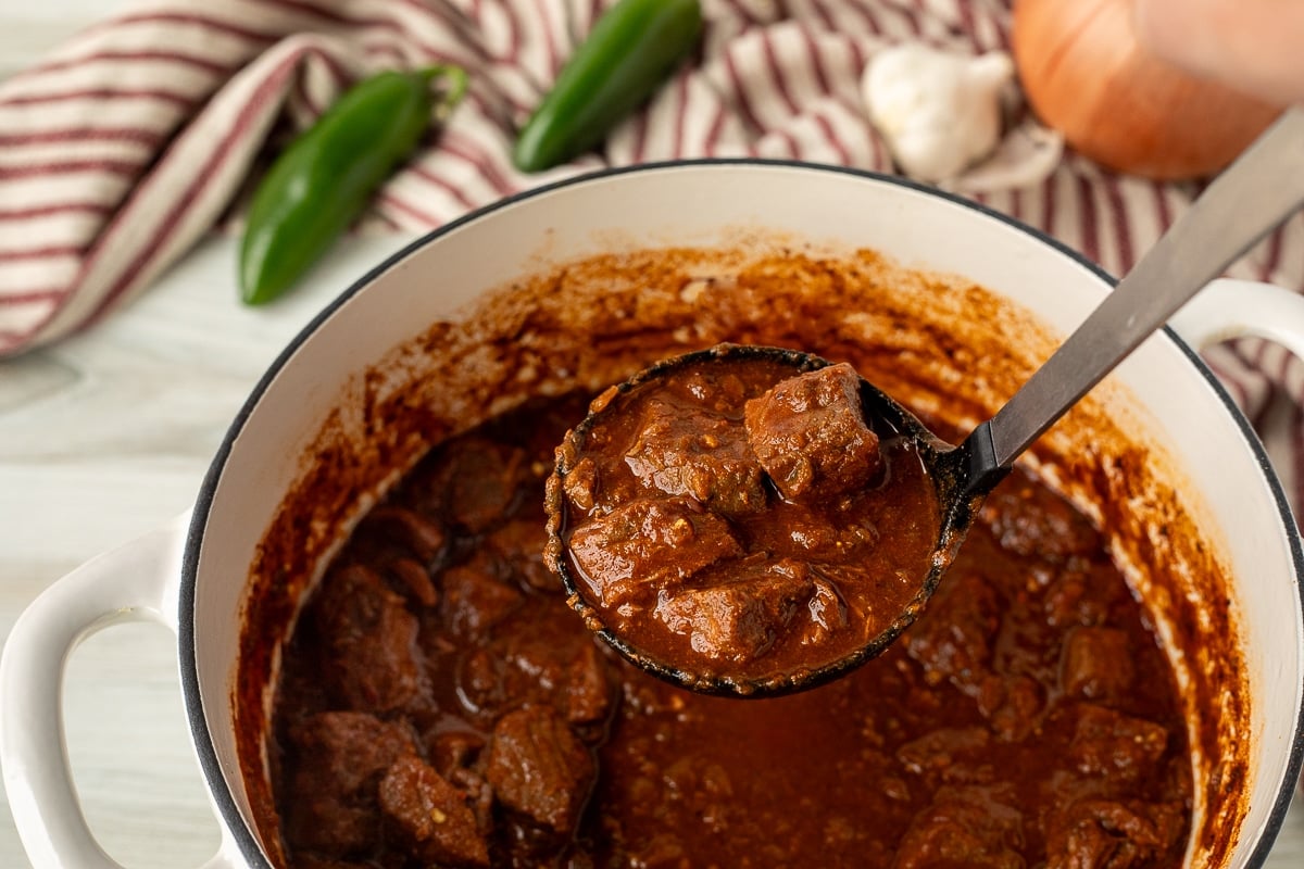 Ladle with a scoop of Texas Chili.