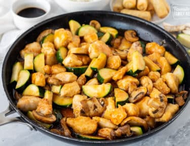 Skillet of Panda Express Mushroom Chicken with zucchini.