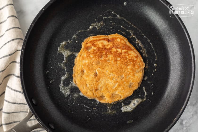 Golden brown Peanut Butter Pancake in a skillet with butter.