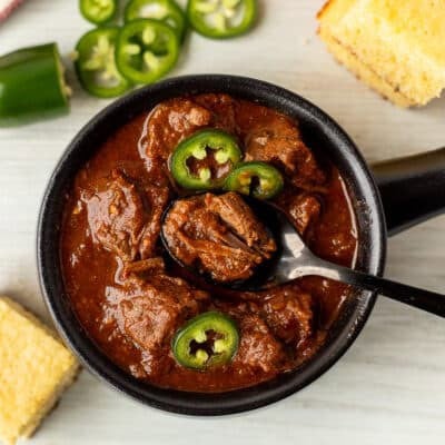 Spoon resting in a bowl of Texas Chili.