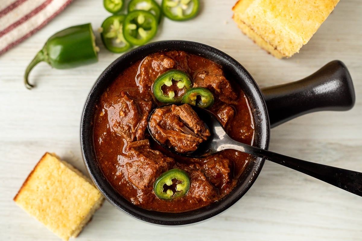 Spoon resting in a bowl of Texas Chili.