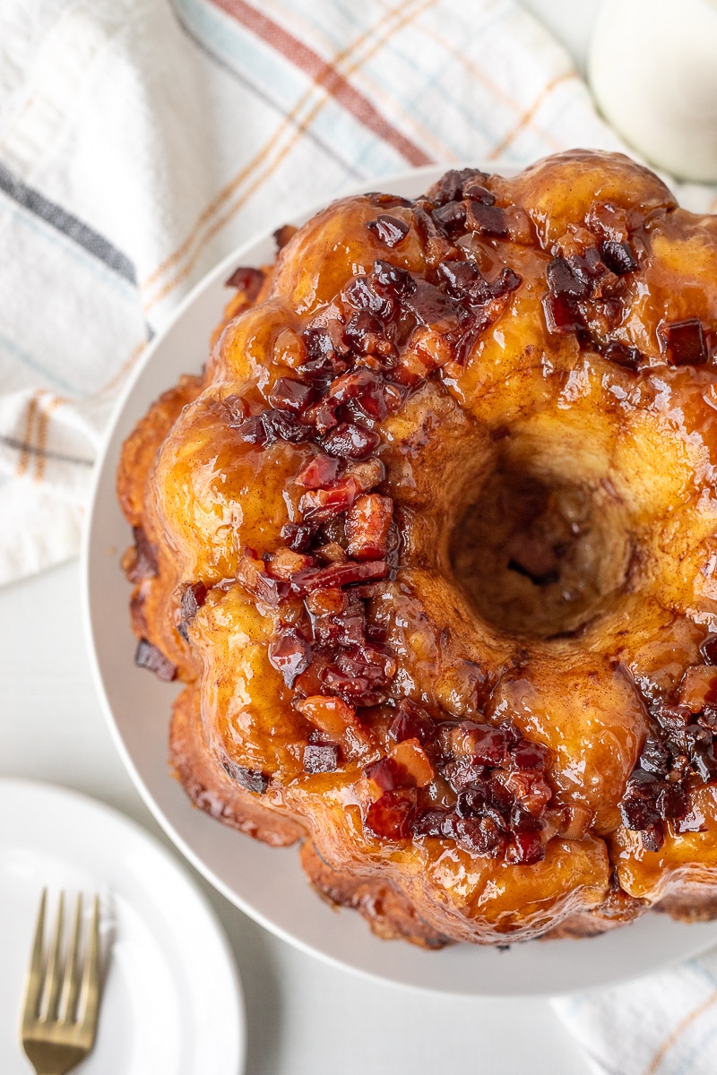 Maple syrup and cut bacon on top of a cinnamon sugar Monkey Bread.