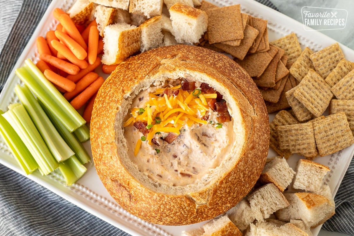 Top view of a Warm Bacon Cheese Dip bread bowl missing a bit of the dip.
