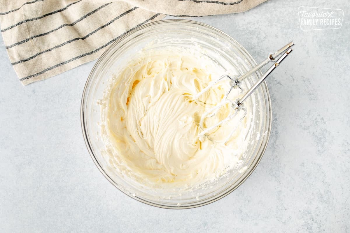 Mixing bowl with whipped cream cheese, powdered sugar and cool whip.