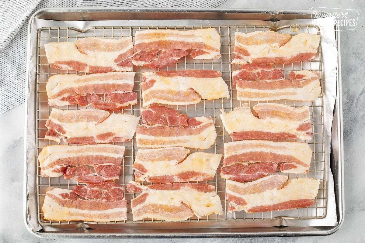 Marinated bacon on top of baking sheet lined with foil.