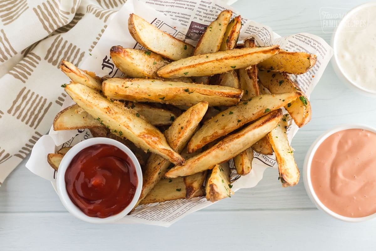 Baked potato wedges in a fry basket with ketchup