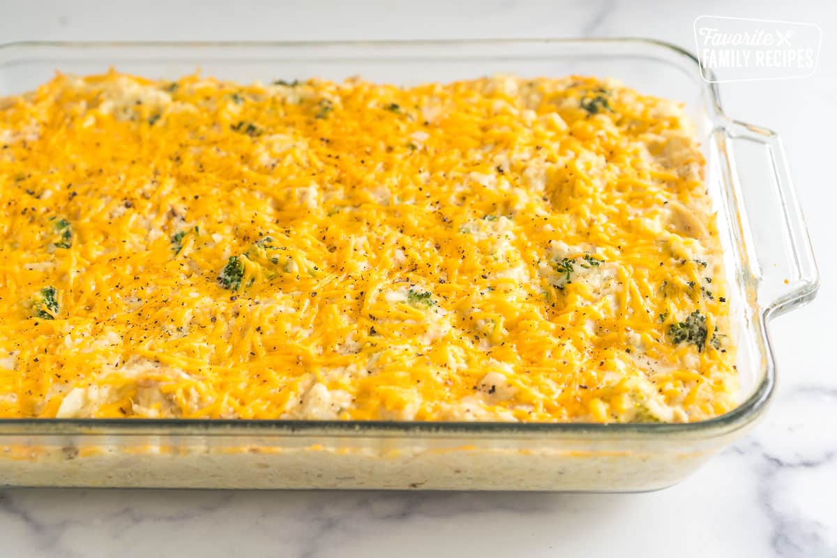 Cooked Chicken Rice Broccoli Casserole in a baking dish topped with cheese.