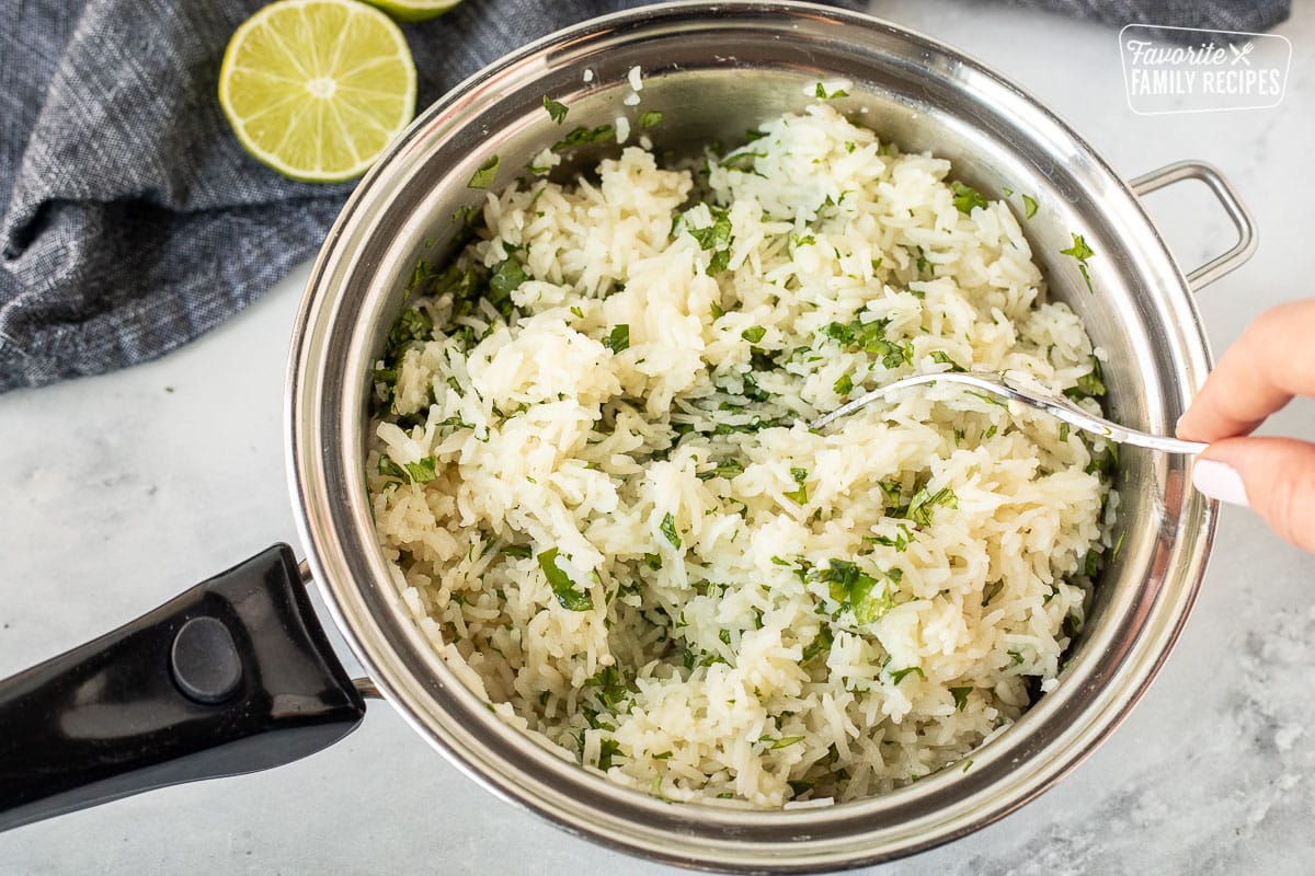 Fluffed up rice with a fork.