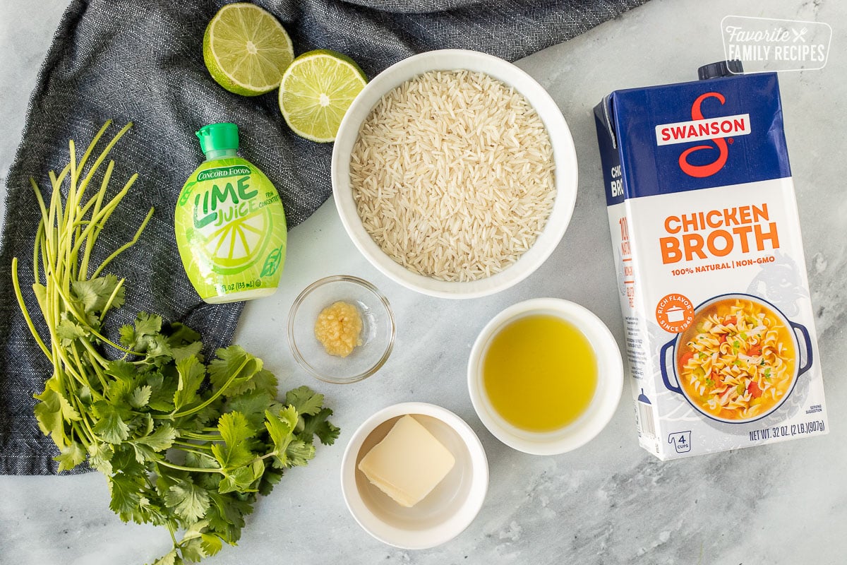 Ingredients to make Chipotle Rice including rice, lime juice, chicken broth, olive oil, butter, minced garlic and cilantro.