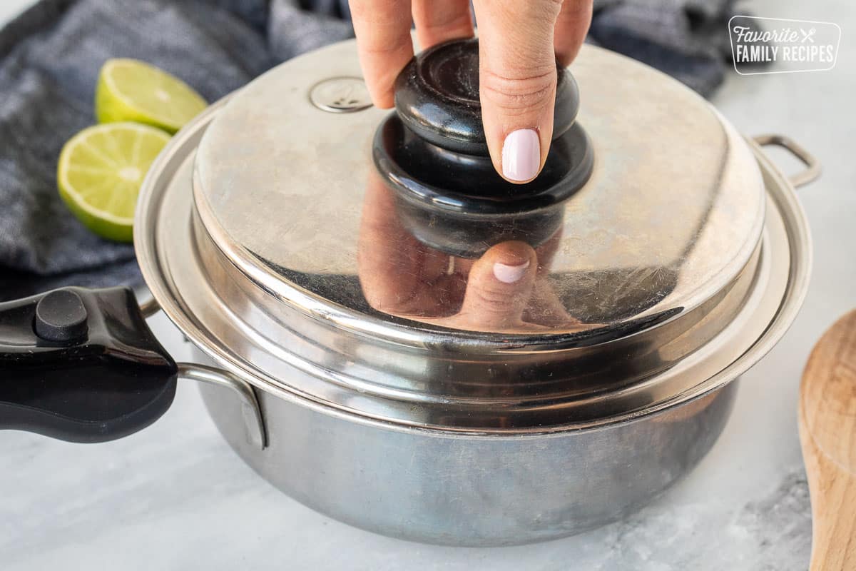 Placing a lid on saucepan.