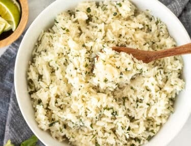 Spoon of Chipotle Rice in a bowl.