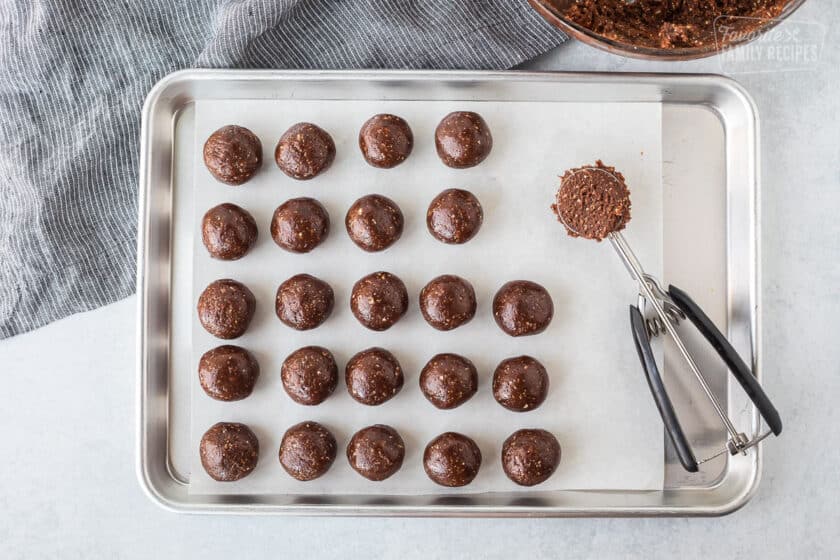 Chocolate protein balls rolled and placed on a cookie sheet