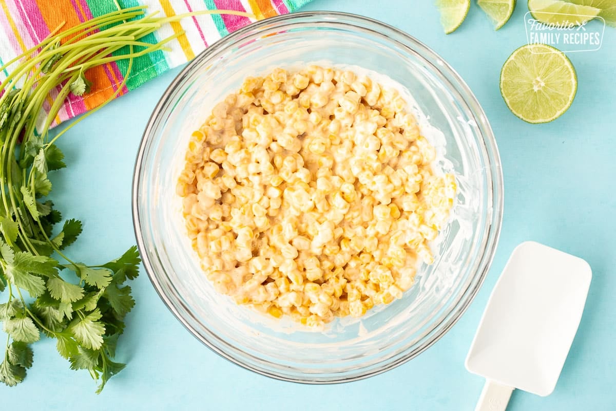 Mixed corn and sauce in a mixing bowl.