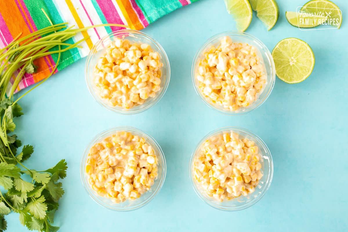 Four cups with creamy corn.