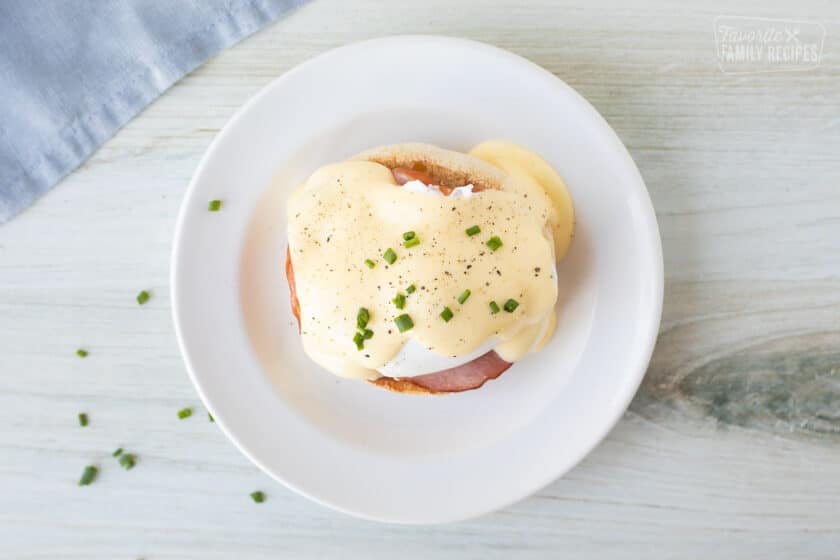 and eggs benedict with chives and cracked pepper to garnish