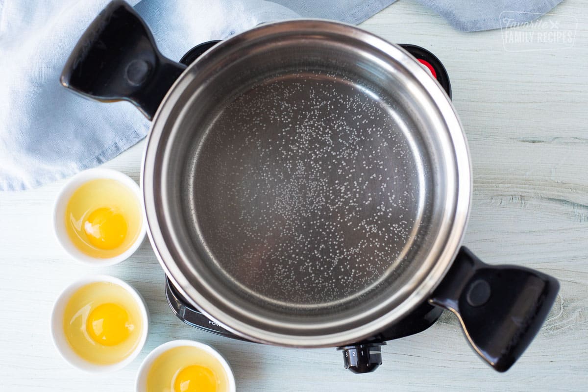 Water boiling in a pot to poach eggs