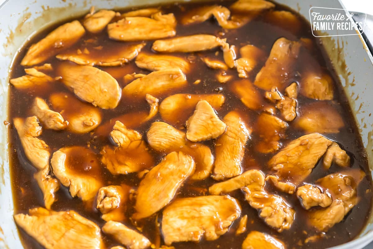 Sliced chicken cooking in a brown sauce