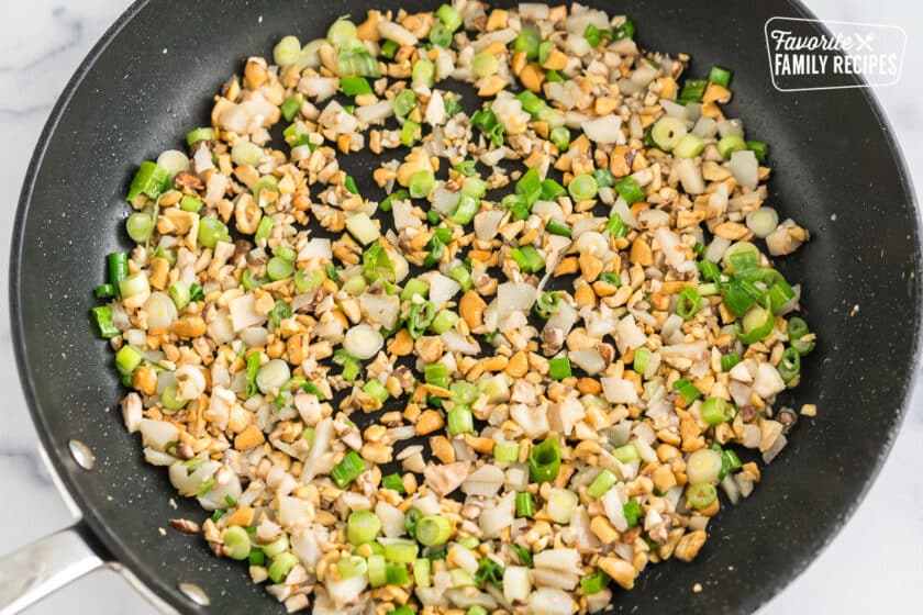 cooked veggies and nuts in a pan