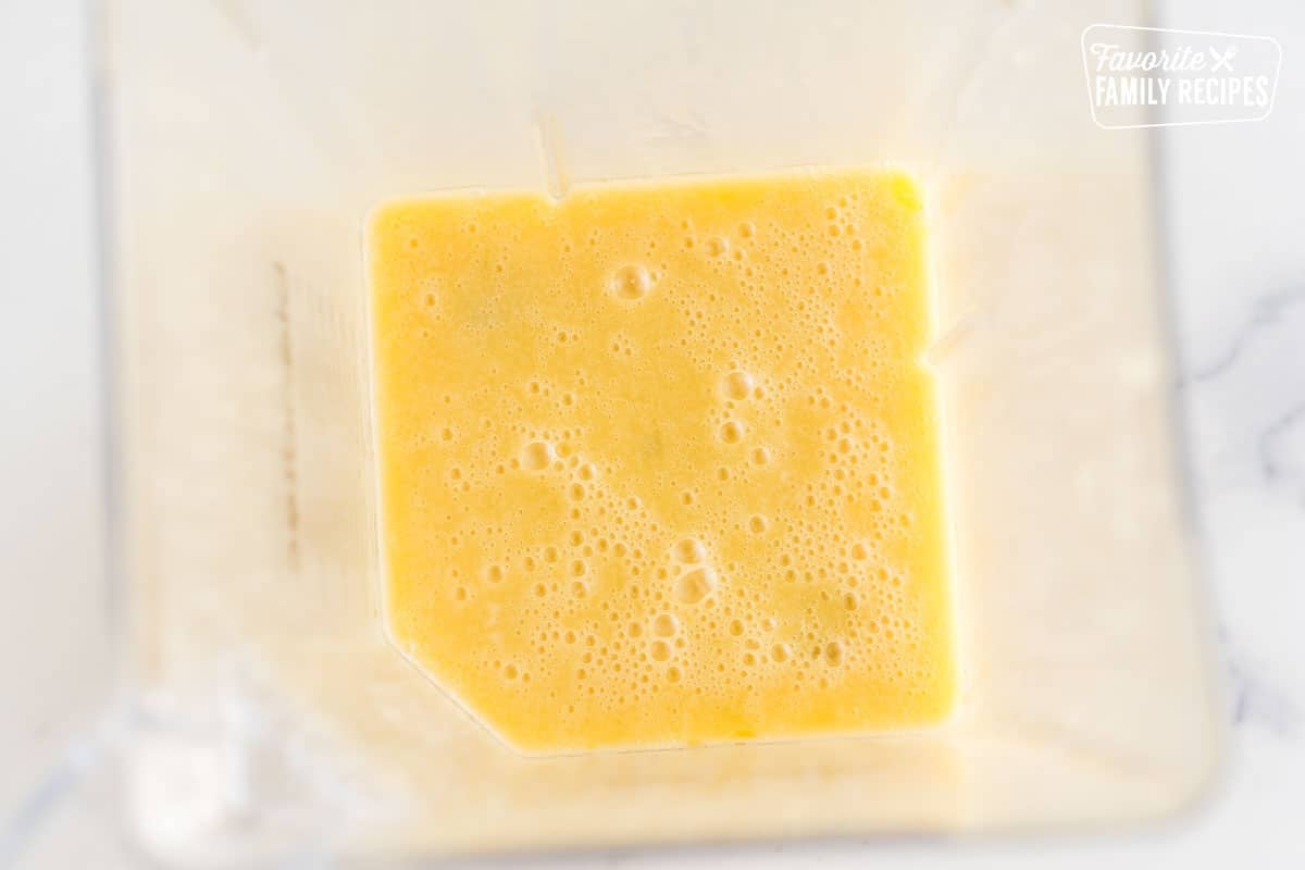 Yellow vinaigrette dressing in a blender