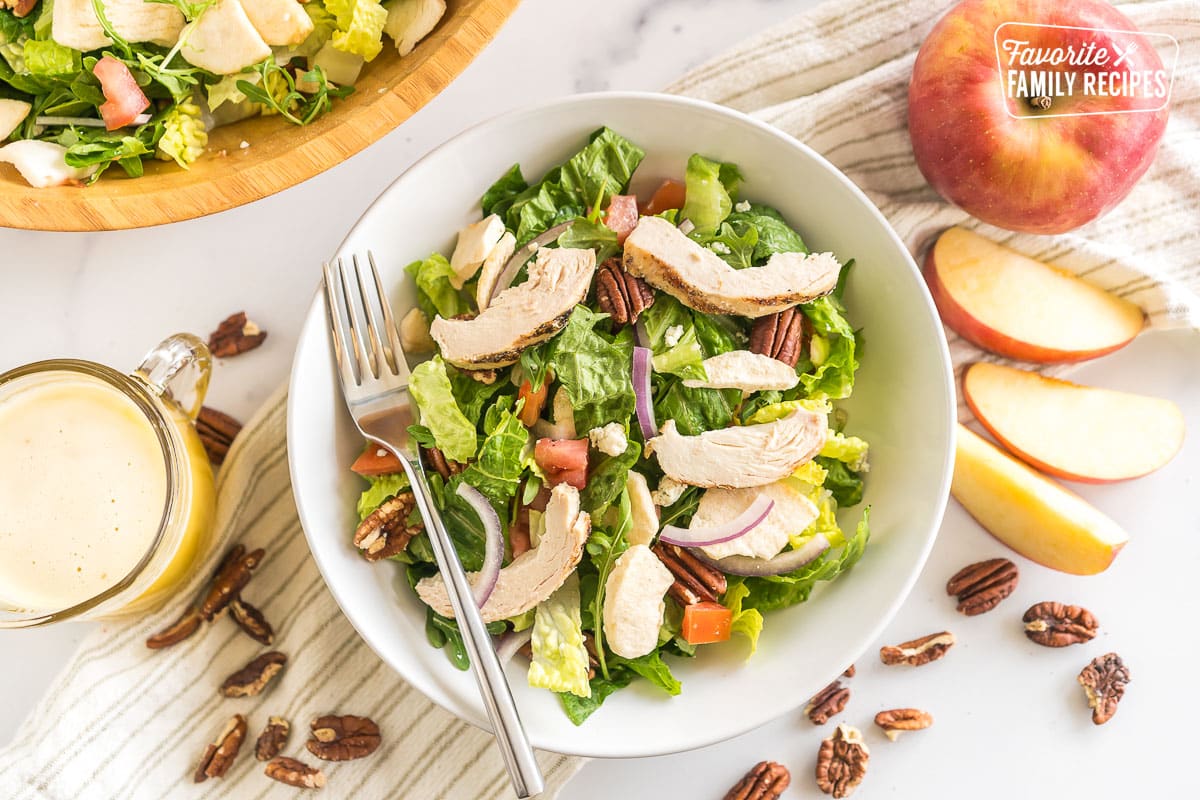 Panera Bread Fuji Apple Salad in a bowl topped with chicken