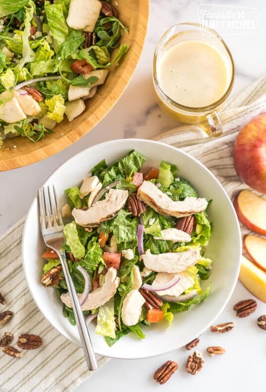 Panera Bread Fuji Apple Salad in a bowl topped with chicken