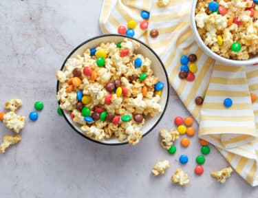 Overhead shot of two bowls of Peanut Butter Popcorn with m&m's