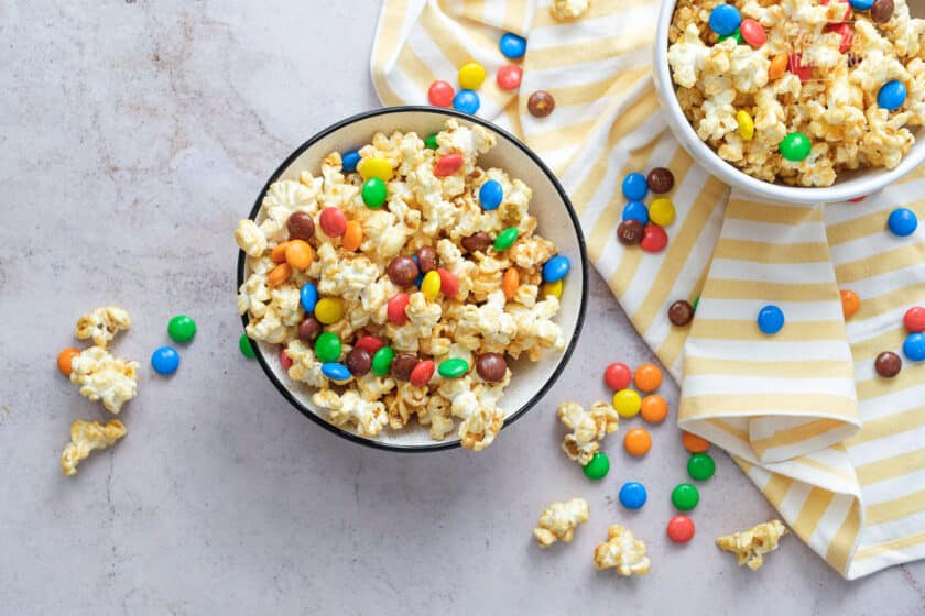 Overhead shot of two bowls of Peanut Butter Popcorn with m&m's