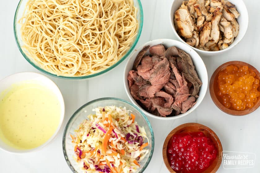 Ingredients to make Satu'li bowls including noodles, slaw, chicken, beef, and boba balls