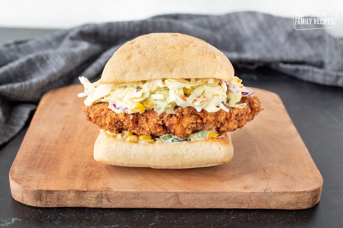 Constructed Southern Fried Chicken Sandwich with coleslaw and a corn sauce.