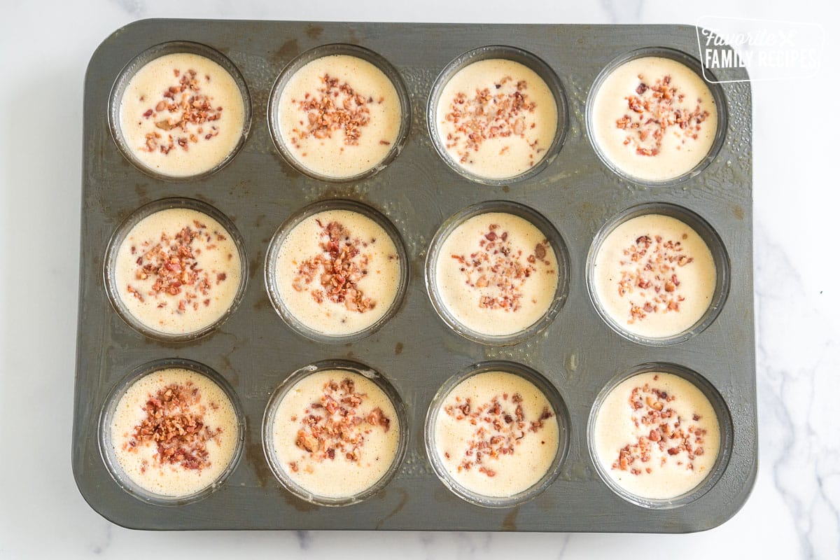 unbaked egg bites in a muffin tin